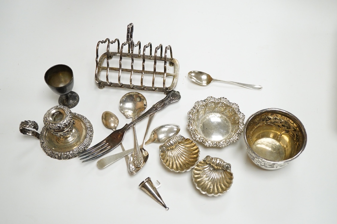 A collection of small silver, to include a late Victorian seven bar toast rack, by Edward Gilbert, London, 1887, length 13.3cm, a late Victorian bowl, pair of shell salts, nut dish, egg cup, Georgian chamberstick(part of